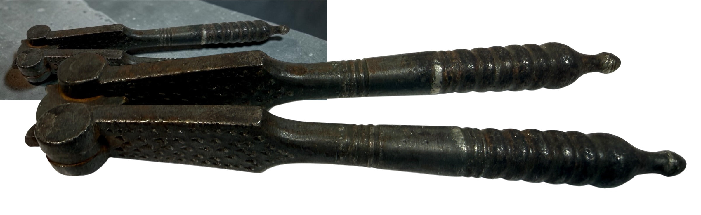 Antique Victorian reversible double nutcracker in iron with decorative handles and textured jaws. Collectible 19th-century kitchen tool.