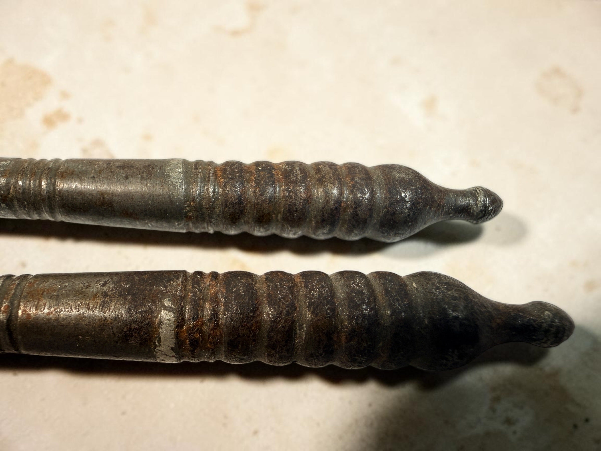 Antique Victorian reversible double nutcracker in iron with decorative handles and textured jaws. Collectible 19th-century kitchen tool.