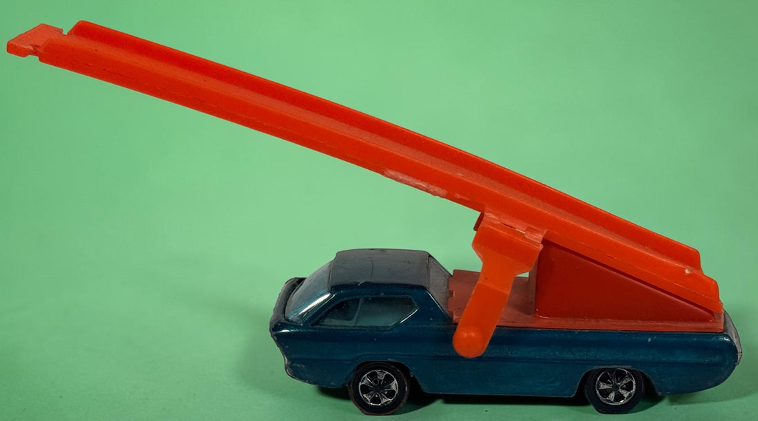 Vintage Hot Wheels Sky Show Deora with orange launcher, metallic blue-green finish and Hong Kong base. Redline-era Mattel collectible; airplane missing.