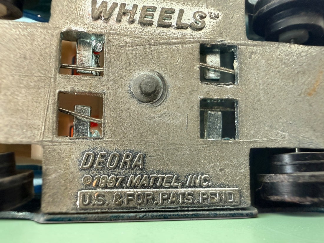 Vintage Hot Wheels Sky Show Deora with orange launcher, metallic blue-green finish and Hong Kong base. Redline-era Mattel collectible; airplane missing.