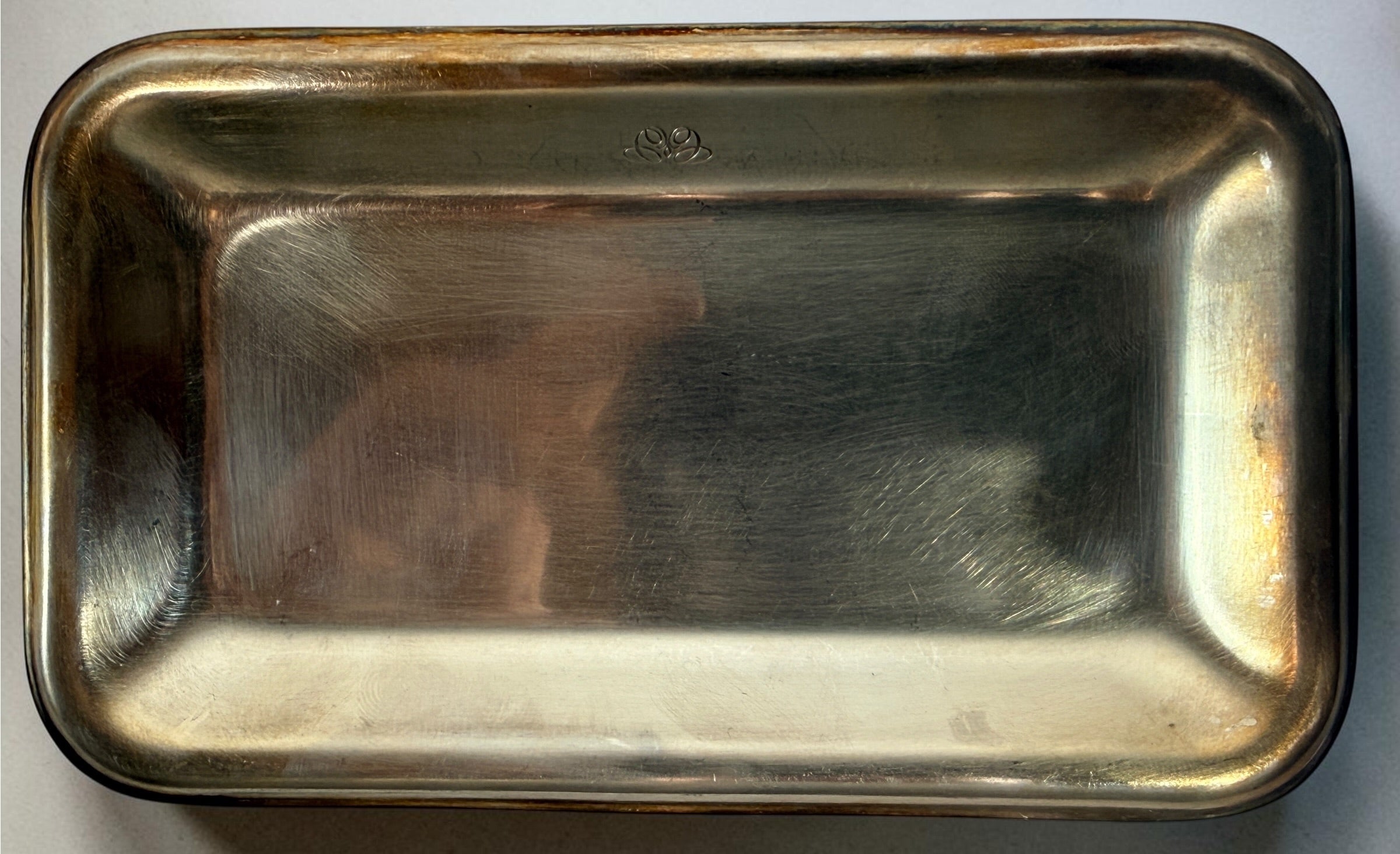  Set of three vintage Sambonet silver-plated trays made in Italy. Rectangular trays with decorative emblems and visible vintage wear.