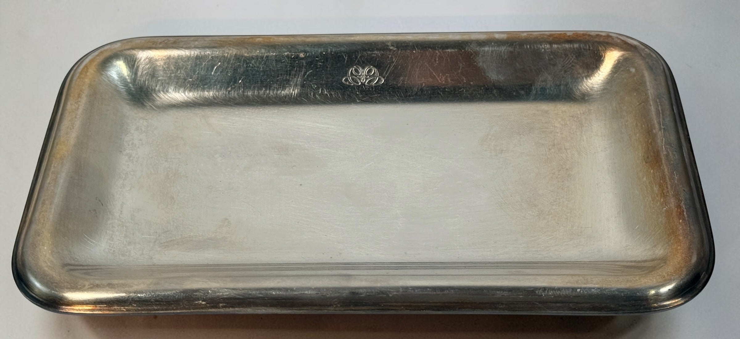  Set of three vintage Sambonet silver-plated trays made in Italy. Rectangular trays with decorative emblems and visible vintage wear.