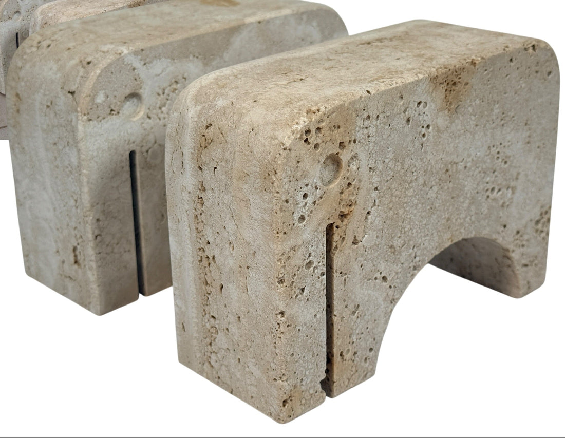 Pair of travertine elephant bookends attributed to Fratelli Mannelli. Sculptural mid-century modern style with warm, naturally textured stone