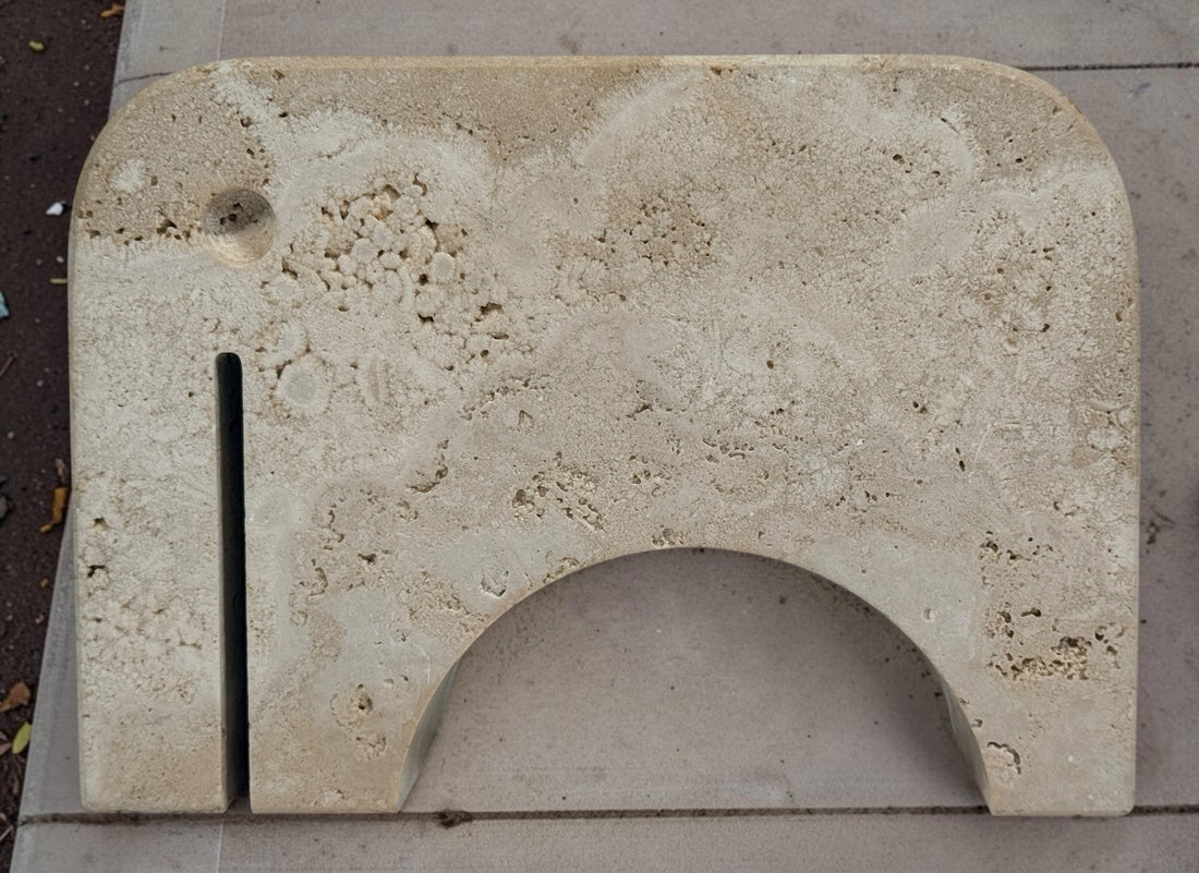 Pair of travertine elephant bookends attributed to Fratelli Mannelli. Sculptural mid-century modern style with warm, naturally textured stone