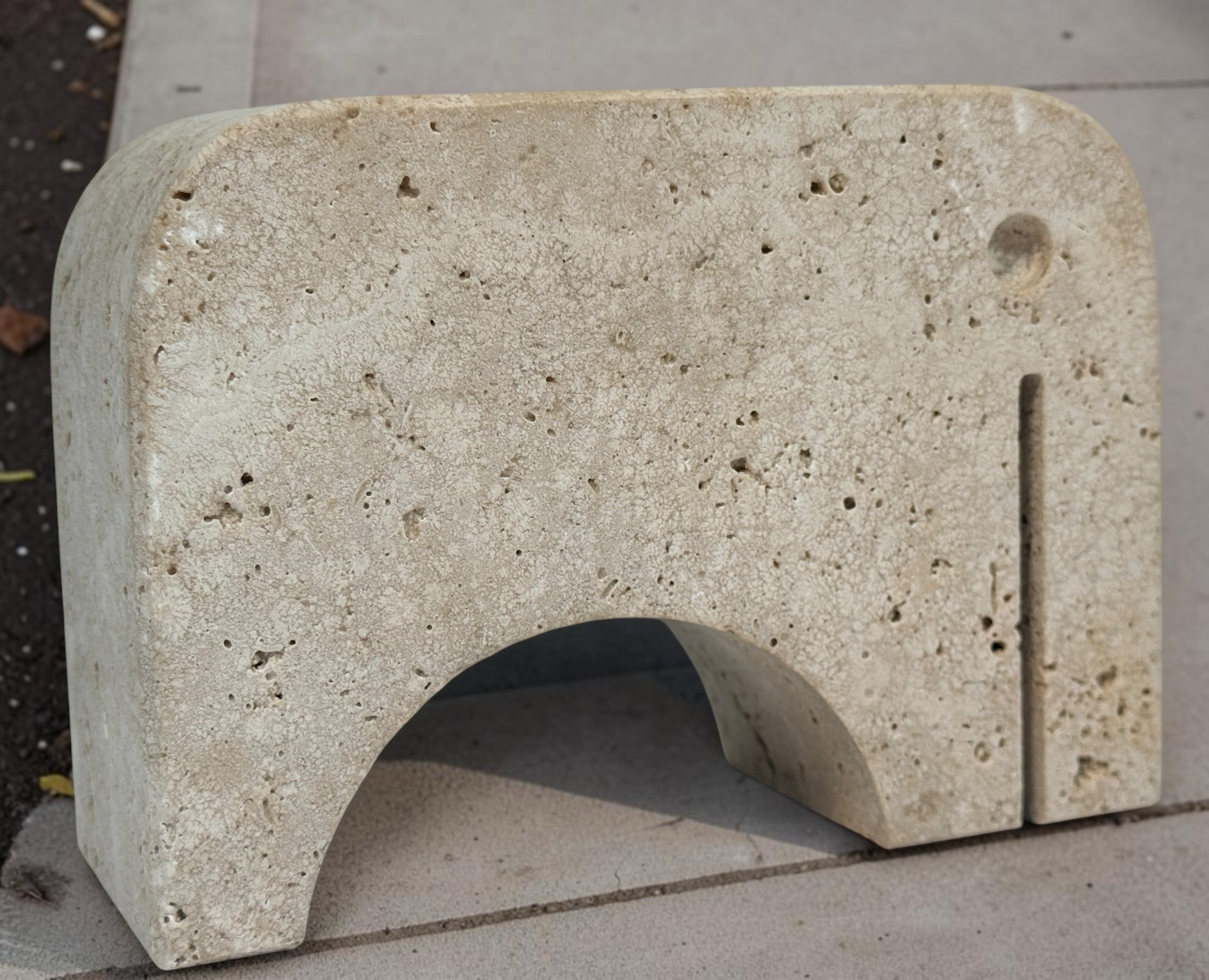 Pair of travertine elephant bookends attributed to Fratelli Mannelli. Sculptural mid-century modern style with warm, naturally textured stone