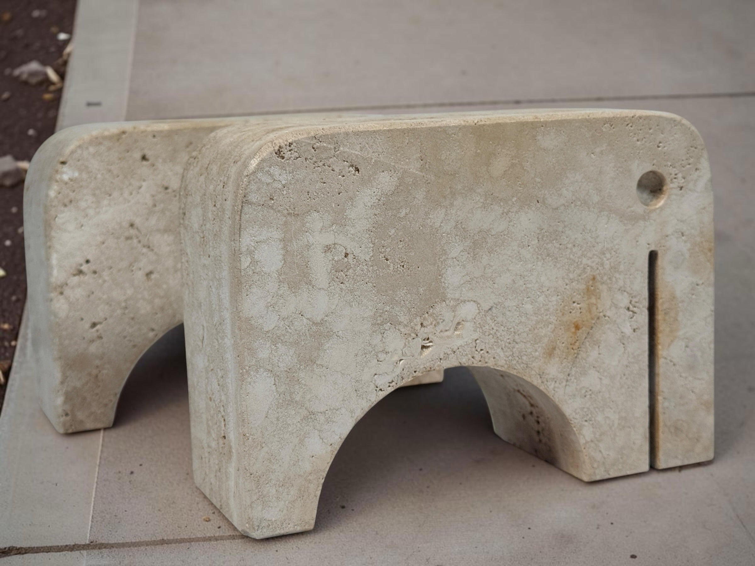 Pair of travertine elephant bookends attributed to Fratelli Mannelli. Sculptural mid-century modern style with warm, naturally textured stone