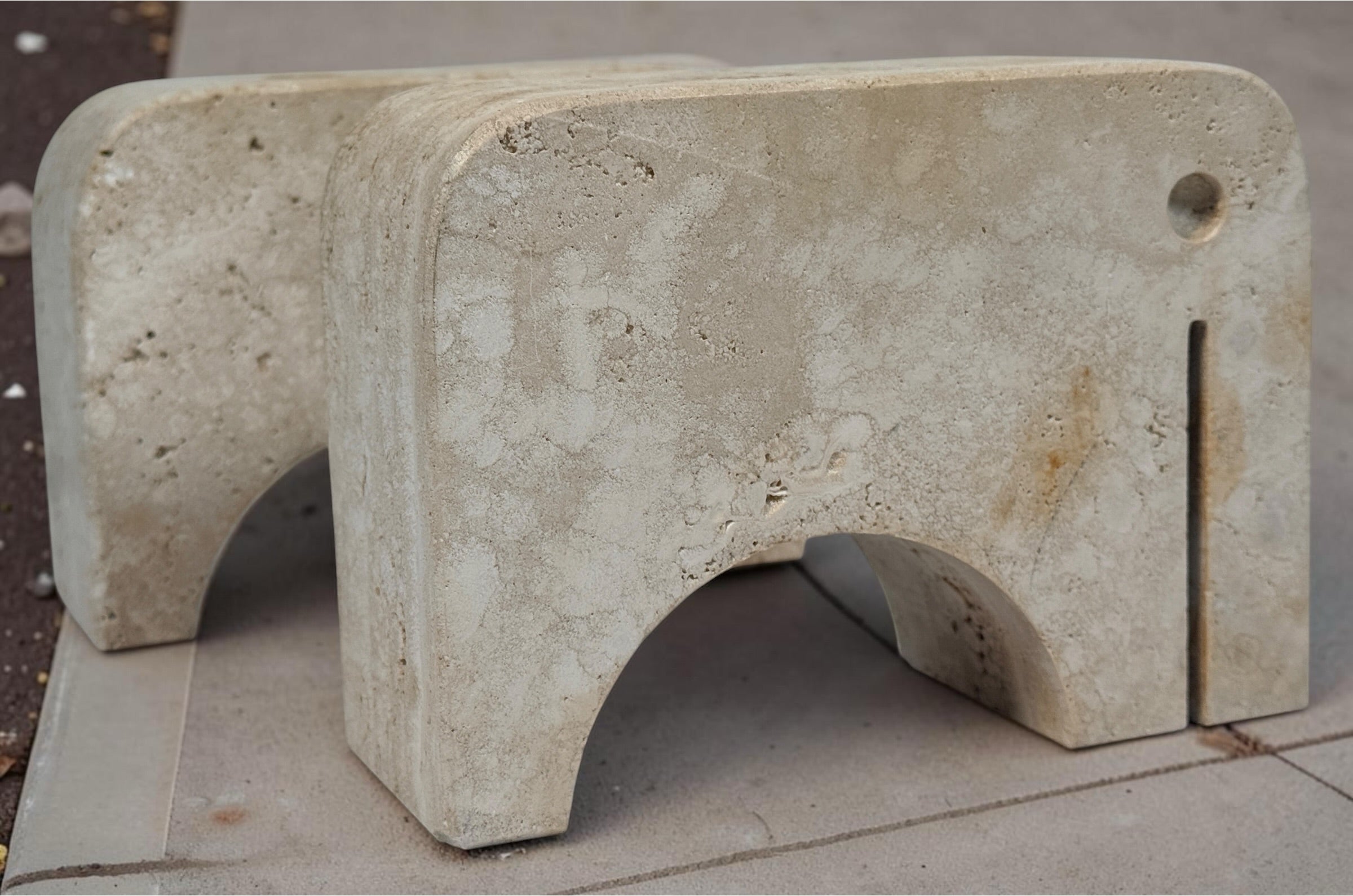 Pair of travertine elephant bookends attributed to Fratelli Mannelli. Sculptural mid-century modern style with warm, naturally textured stone