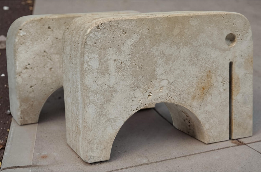 Pair of travertine elephant bookends attributed to Fratelli Mannelli. Sculptural mid-century modern style with warm, naturally textured stone