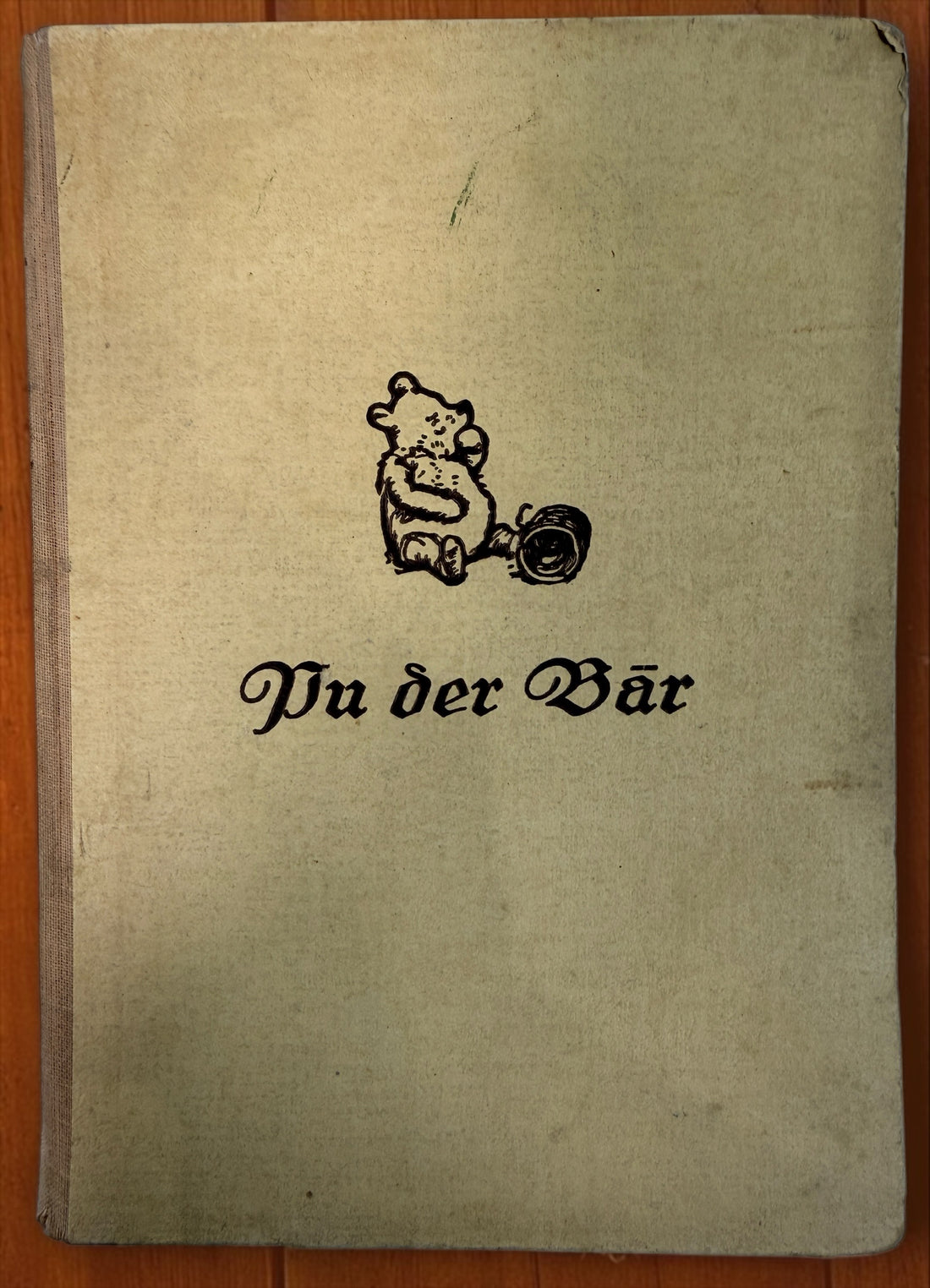 Discover a vintage German edition of Pu der Bär by A. A. Milne, illustrated by E. H. Shepard. Undated hardcover with visible age and wear.