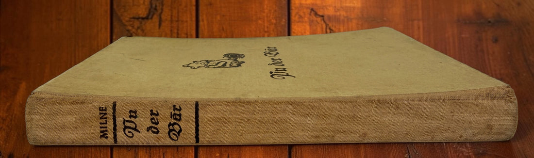 Discover a vintage German edition of Pu der Bär by A. A. Milne, illustrated by E. H. Shepard. Undated hardcover with visible age and wear.