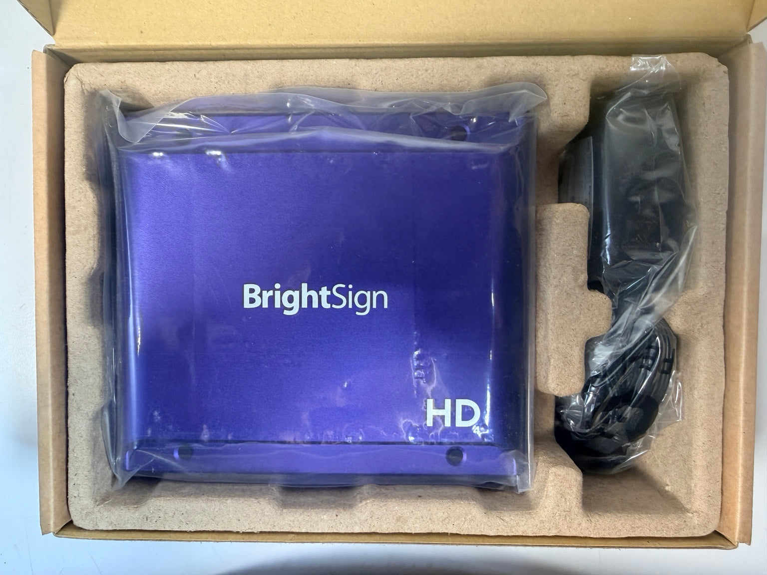 BrightSign HD224 and adapter in packaging