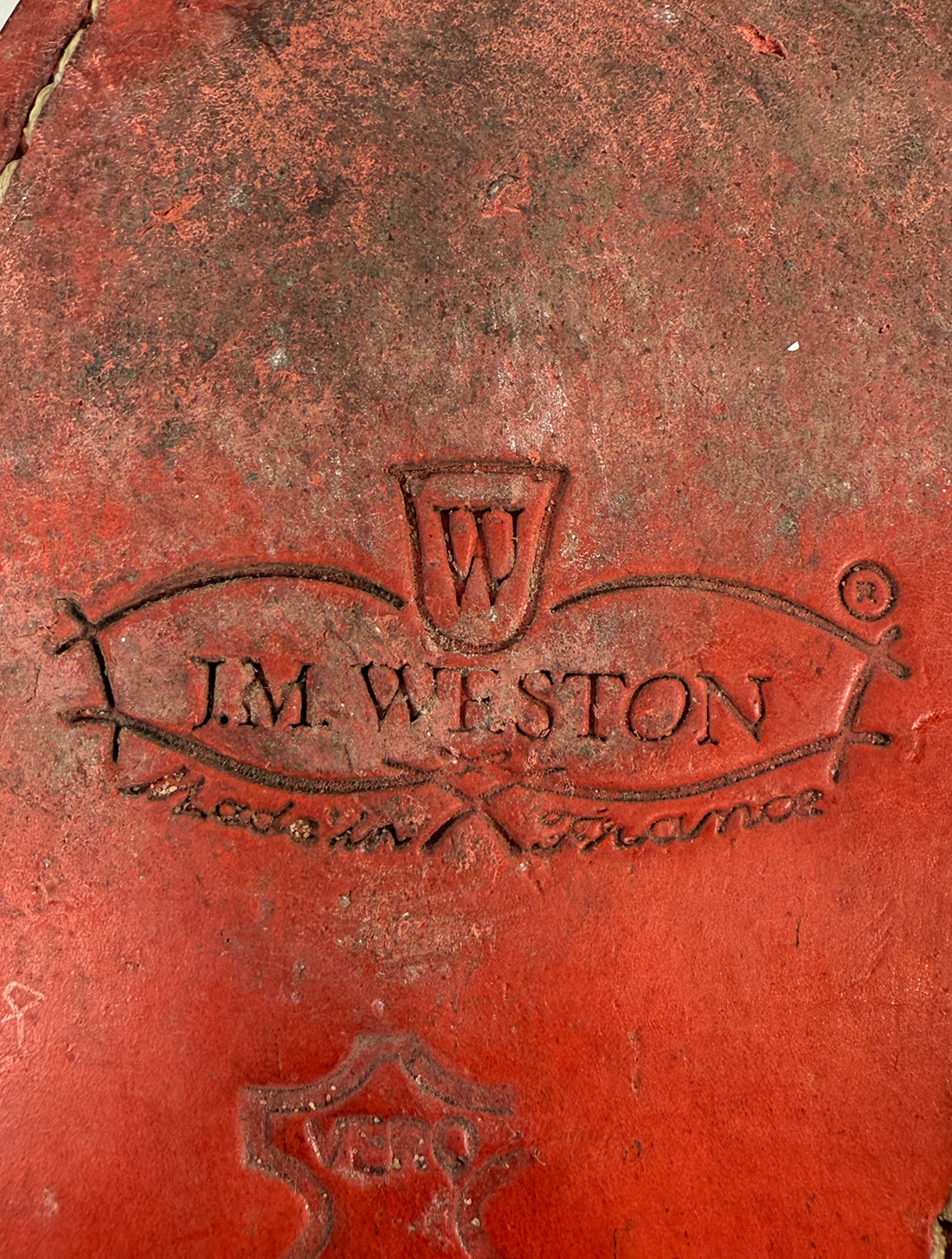 Red leather-bound book with 'J.M. Weston' branding on a red background