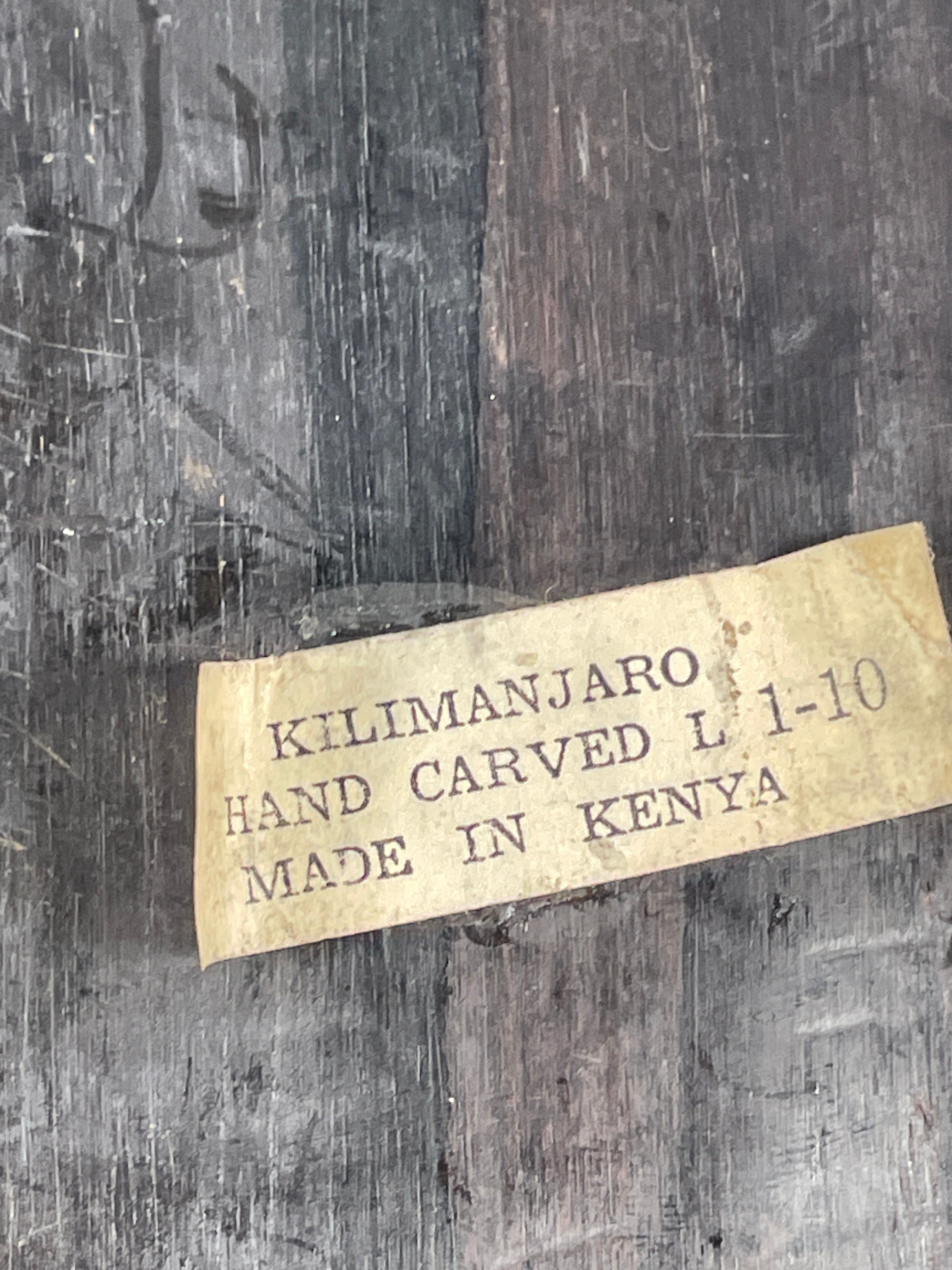 Kilimanjaro hand-carved item label on a wooden surface