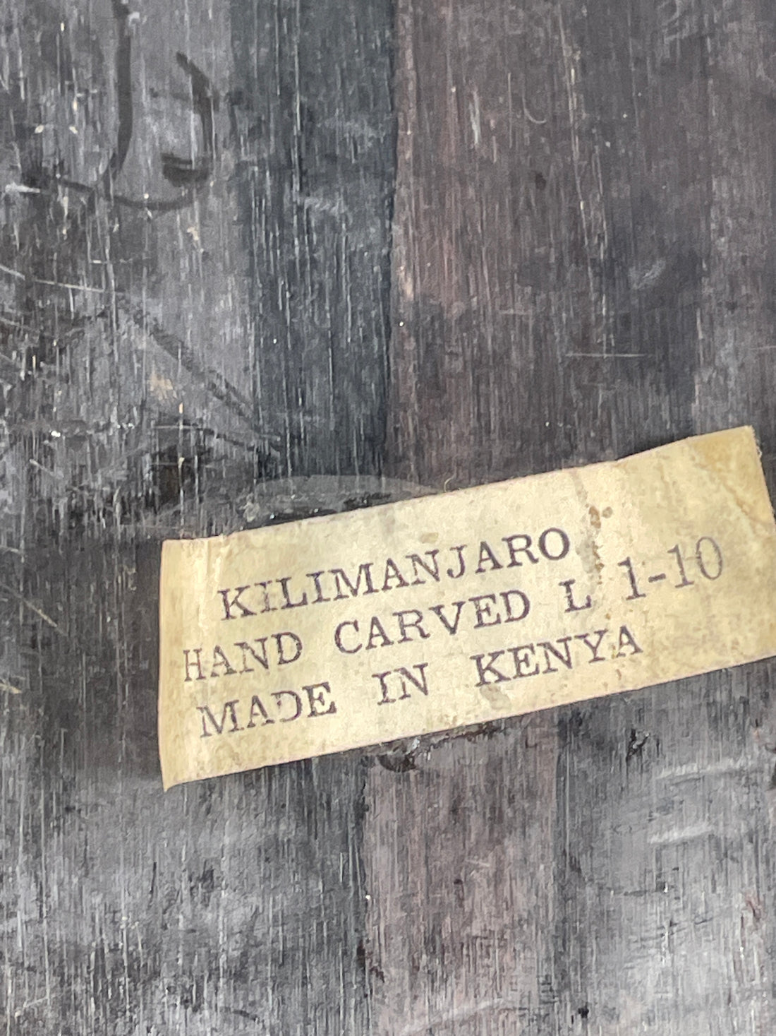 Kilimanjaro hand-carved item label on a wooden surface