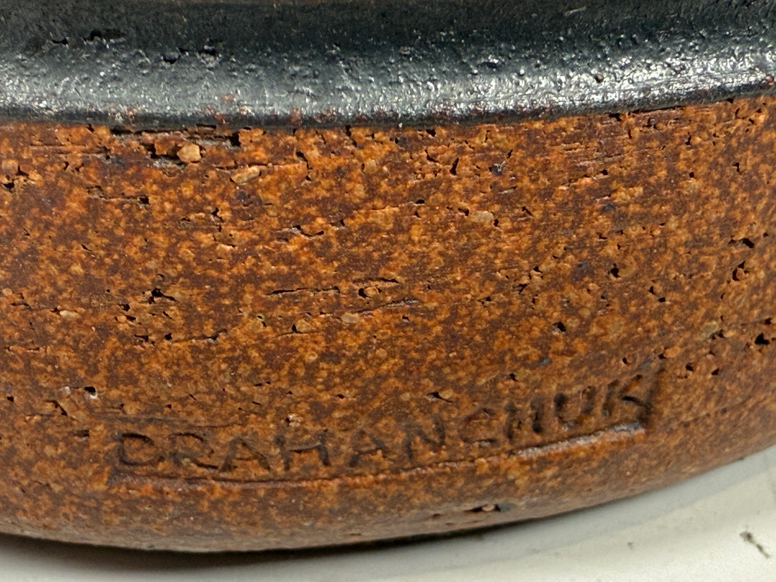 Close-up of a ceramic bowl with 'Drahmanik' branding on a white background