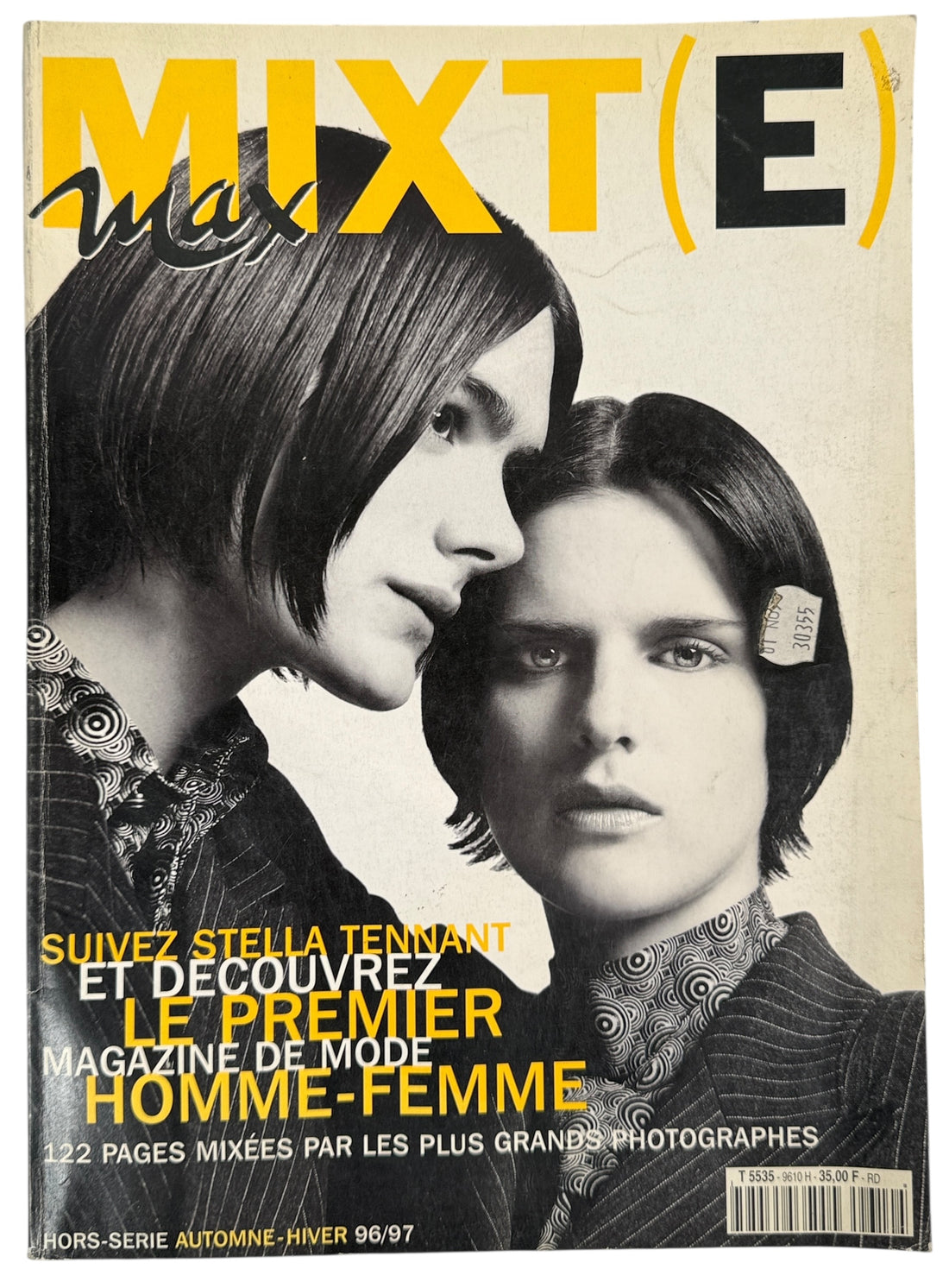 Magazine cover with two people and text about a mixed-gender fashion magazine.
