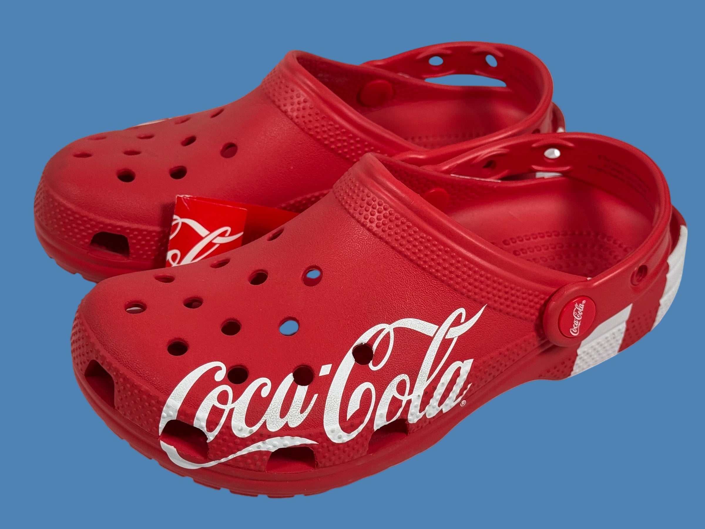 Red clogs with Coca-Cola logo on a white background