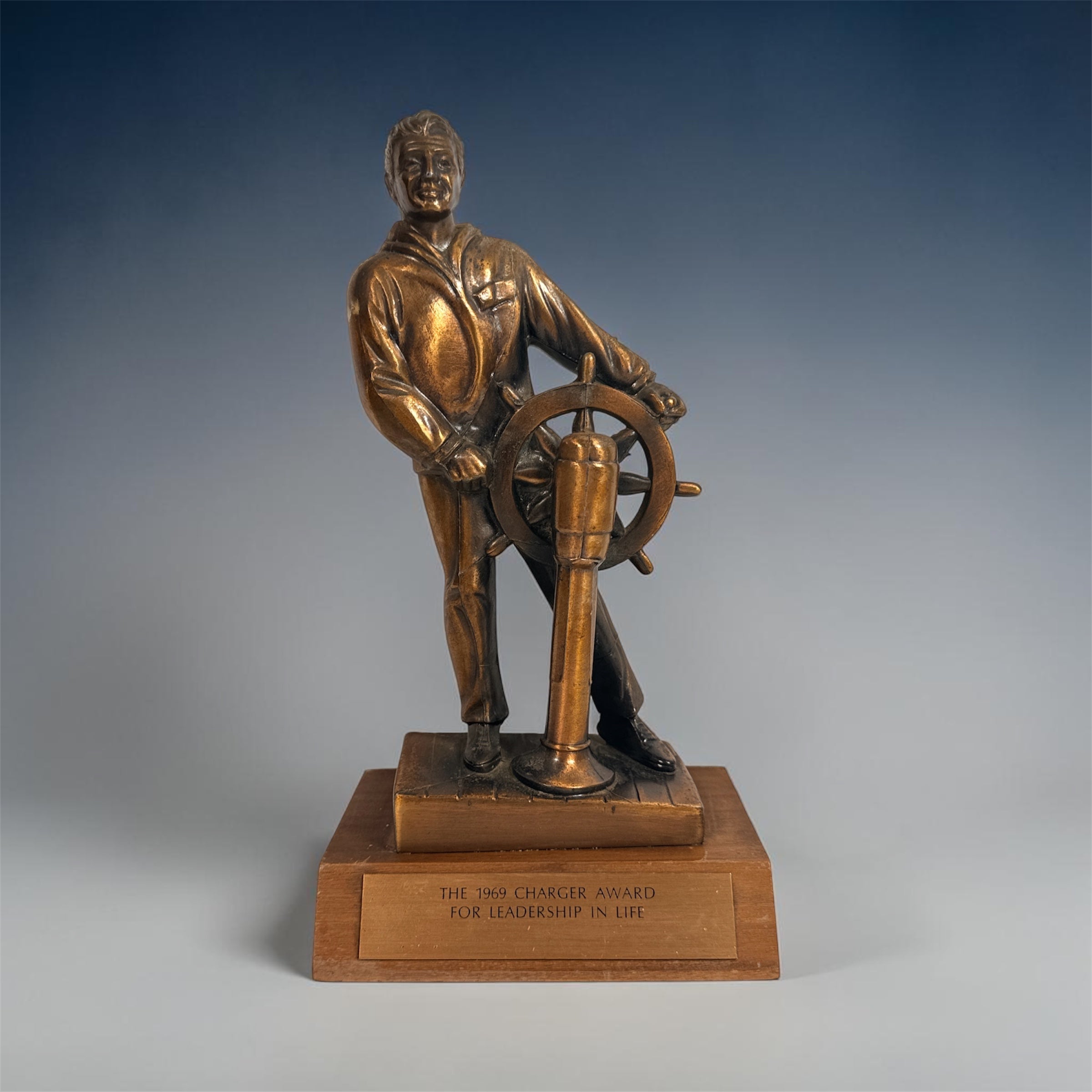 Vintage 1969 sailor helm award statue with bronze finish on wood base. Nautical décor piece with plaque, ideal for maritime collectors or mid-century display