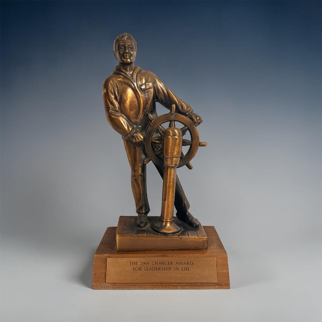 Vintage 1969 sailor helm award statue with bronze finish on wood base. Nautical décor piece with plaque, ideal for maritime collectors or mid-century display