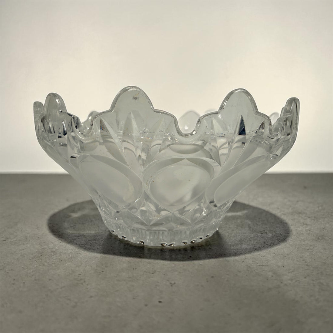 Mid-century pressed glass bowl with frosted thumbprint pattern and scalloped rim. Heavy decorative centerpiece perfect for vintage or retro home decor.
