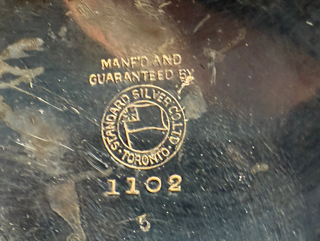 Close-up of a silver hallmark with 'Standard Silver Co.' branding on a dark background.