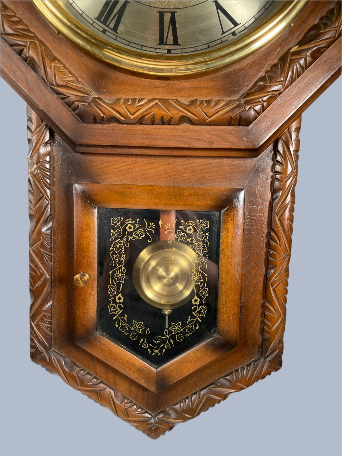 Wooden clock with intricate carvings on a white background