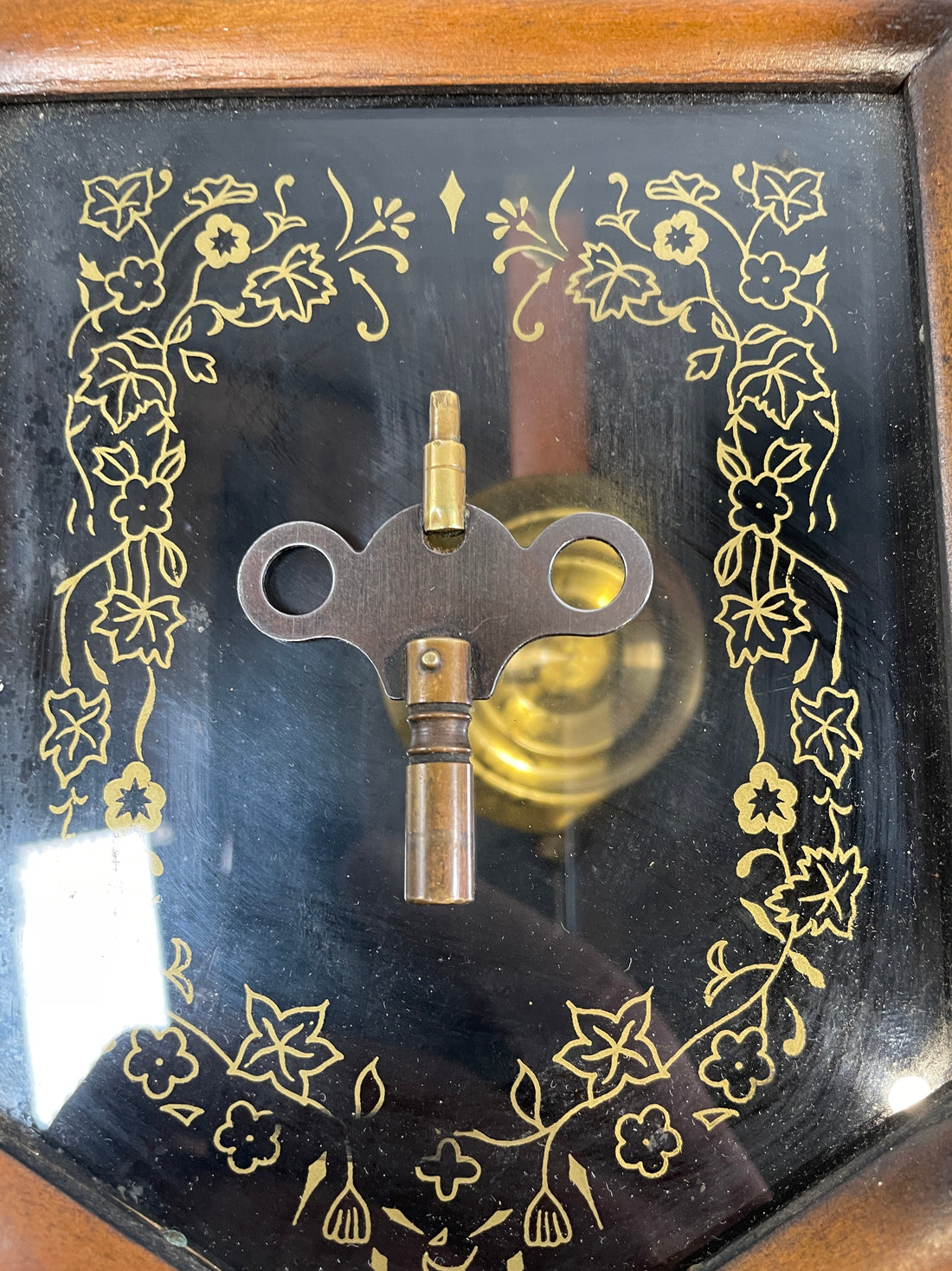 Mechanical key on a decorative clock face with floral patterns
