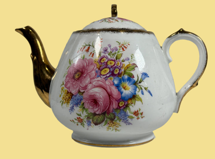Teapot with floral design on a white background