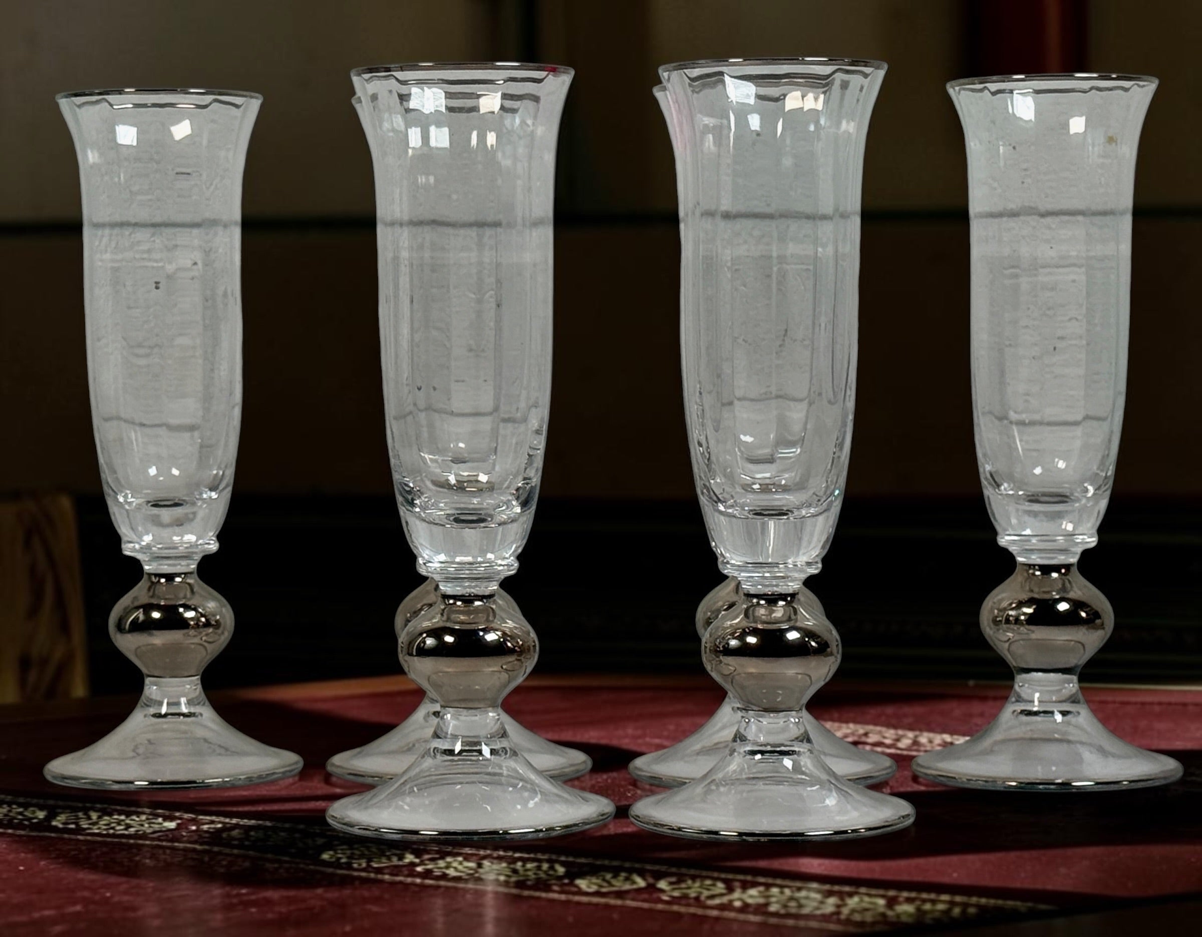 Set of six champagne flutes with silver-tone rims and rounded stems