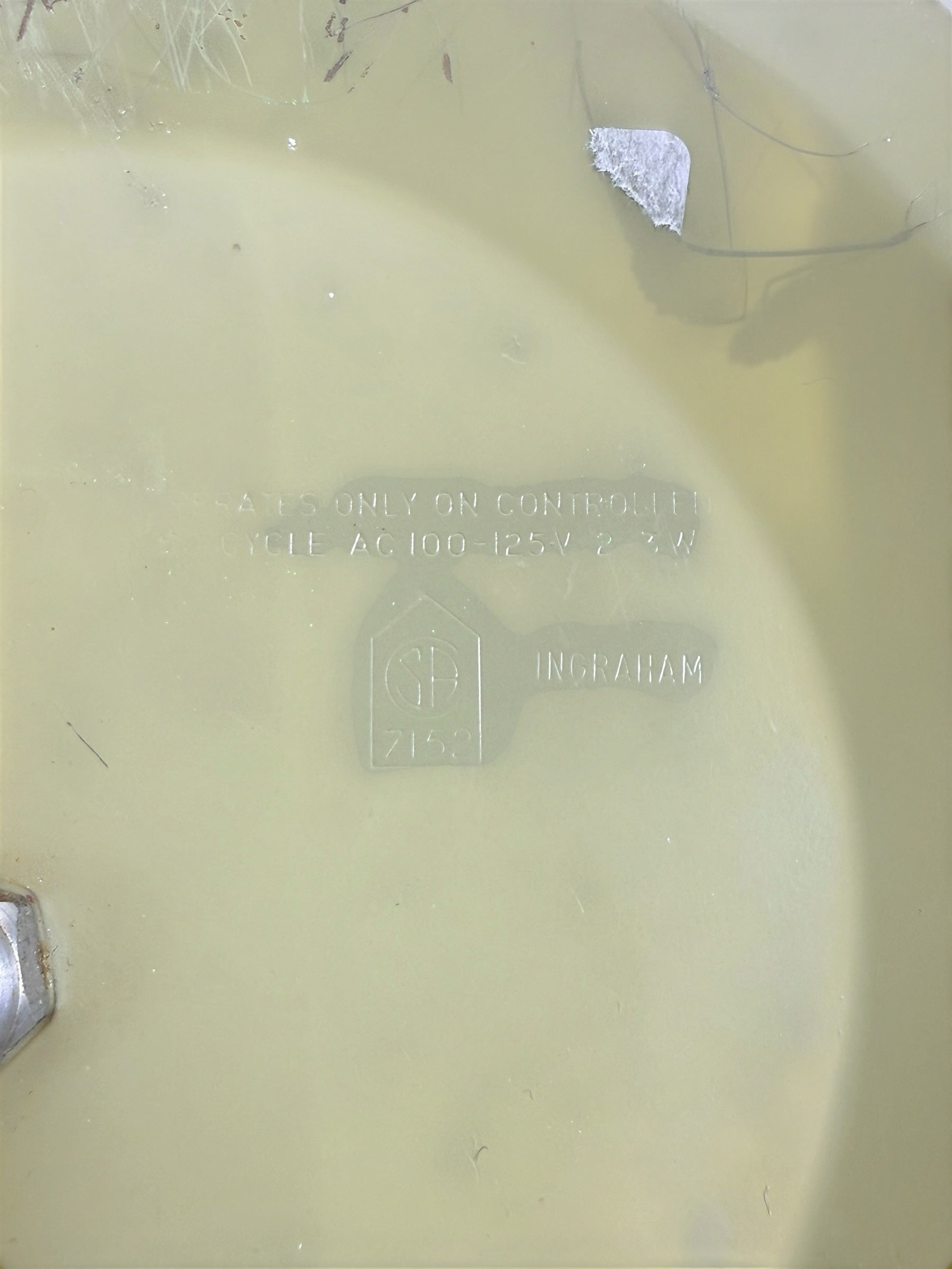 Back casing of a vintage Ingraham electric wall clock from Éco-Dépôt Montréal with embossed technical specifications.