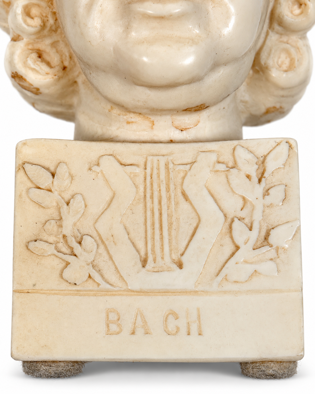 Bach plinth and lyre detail on white background