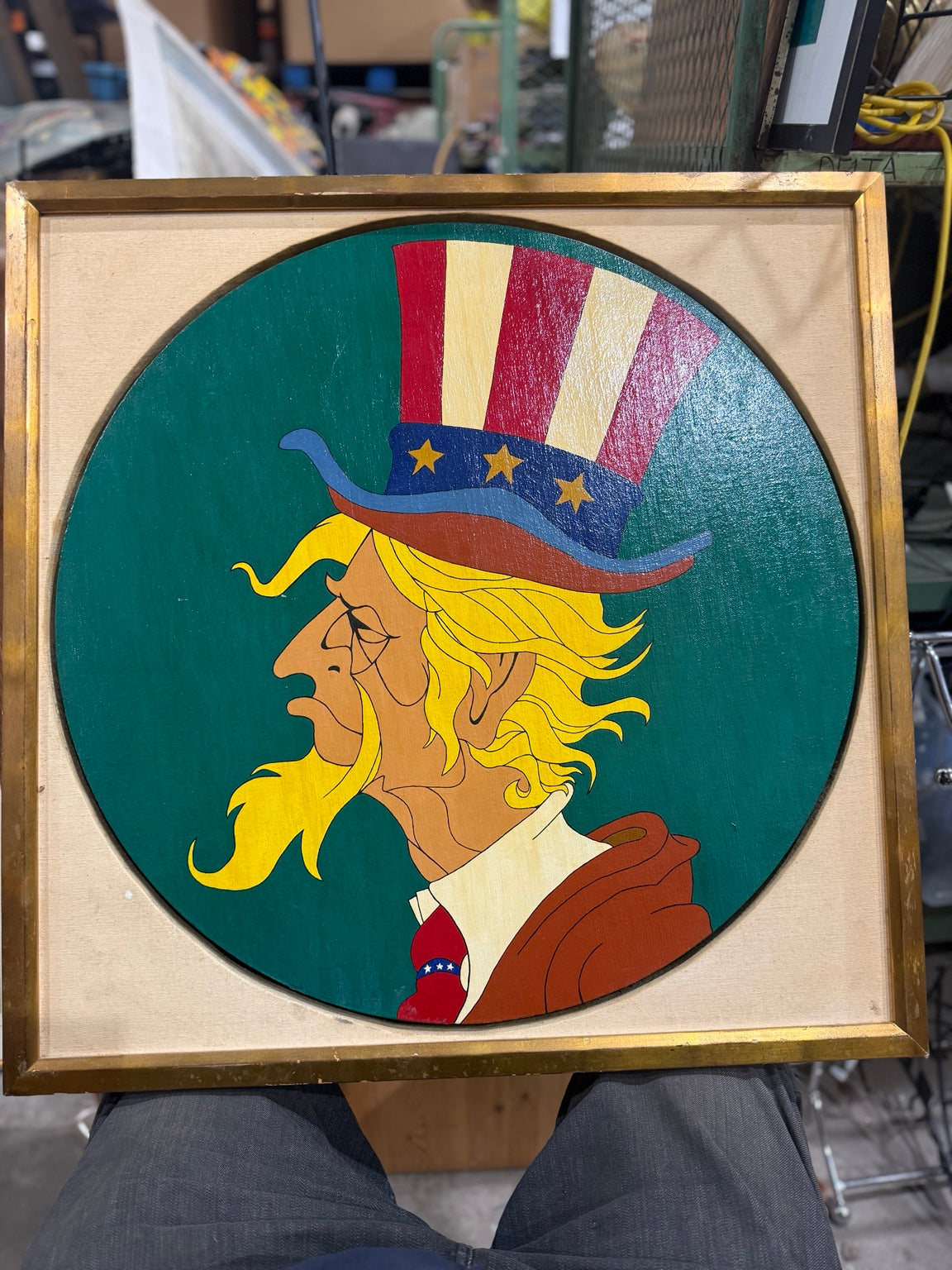 Full view of the Uncle Sam oil painting and its square gold-tone frame, showing frame wear.